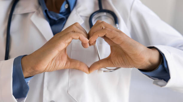 istock Close up cropped shot unknown doctor showing heart gesture 2195528443