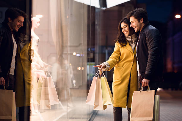 istock Couple Enjoying Shopping and Window Display at Night in Urban Setting 2195529755