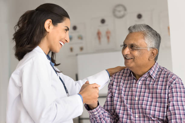 istock Cardiologist touch shoulder holding hand of older patient 2195531280