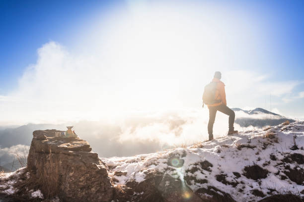 istock Hiker at Sunrise Exploring Snowy Peaks and Vibrant Skies 2195534352