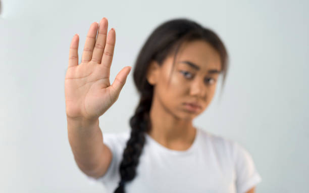 istock Asian girl making stop gesture with her palm 2195534410