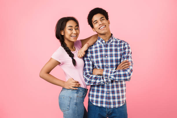 istock Happy african-american couple posing on studio background 2195534496
