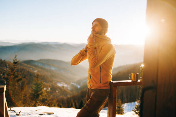 istock Handsome man wearing warm fleece jacket in winter mountains at sunset 2195537657