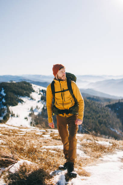 istock Confident man, hiking in snowy mountains in sunny day 2195538697