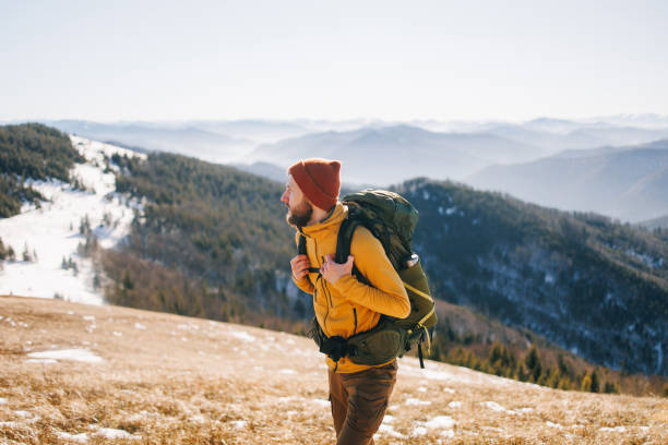 istock Confident man, hiking in snowy mountains in sunny day 2195539429