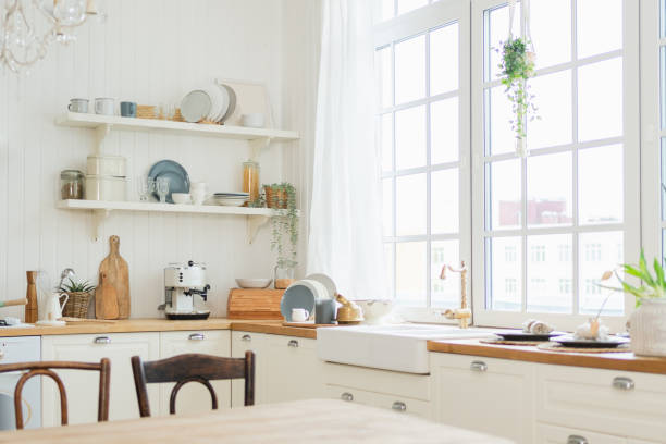 istock Empty white wooden kitchen interior with dining room. Scandinavian classic minimalistic bright kitchen with white and wooden details. Modern white kitchen clean contemporary style interior design. 2195540045