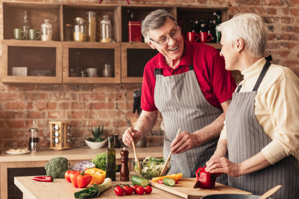 istock Senior couple preparing fresh salad in kitchen 2195544714