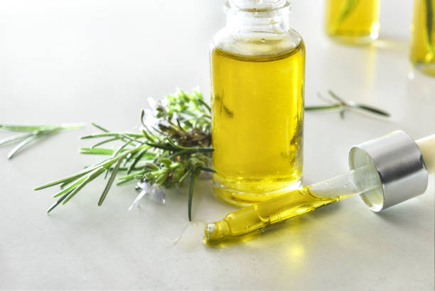 istock Pipette and jar with rosemary oil isolated on white table 2195546777
