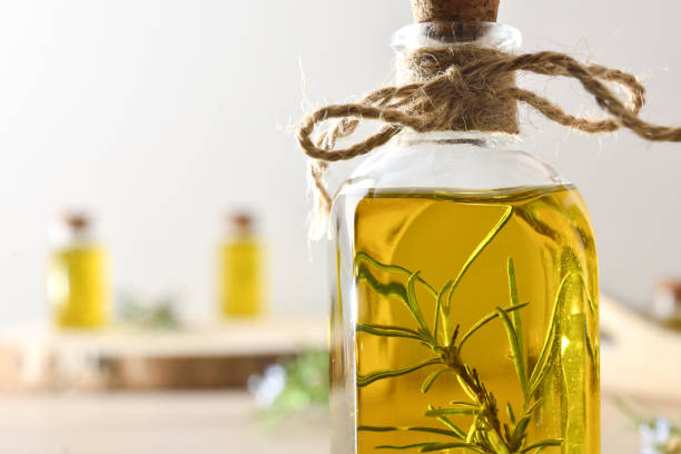 istock Rosemary essence in glass jars with fresh twigs on table 2195546778