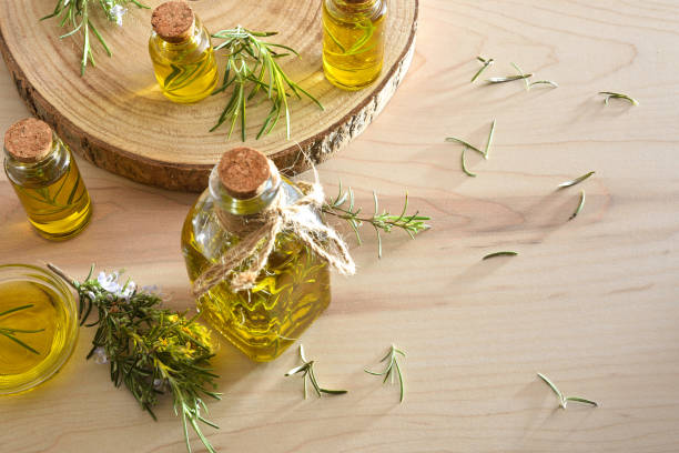 istock Containers with rosemary essential oil on a wooden table 2195546780