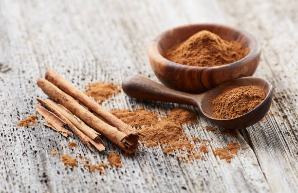 istock Cinnamon powder with cinnamon bark on wooden background 2195547165