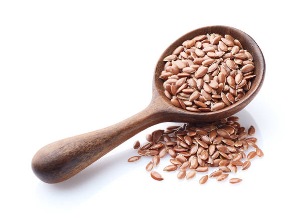 istock Flax seeds in wooden spoon on white background 2195550067