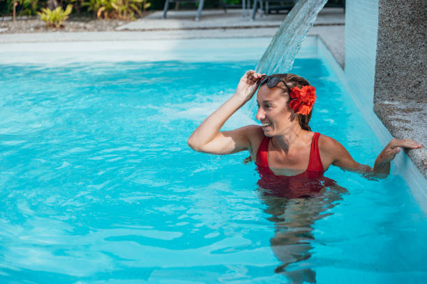 istock Woman in Red Swimsuit Enjoying a Refreshing Pool Day 2195557493