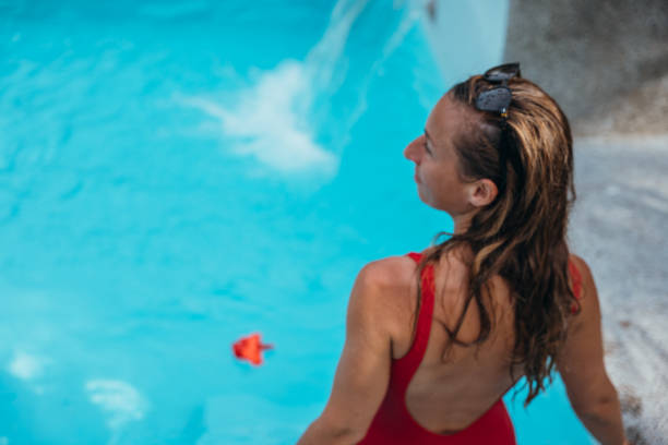istock Woman in Red Swimsuit Relaxing In Pool 2195557798
