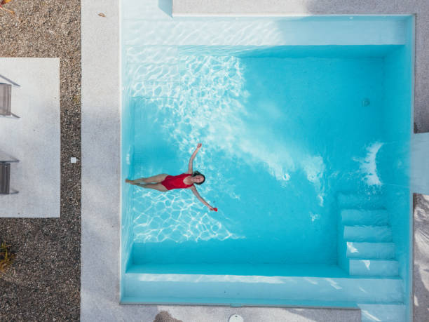 istock Woman Relaxing in a Modern Pool 2195559850