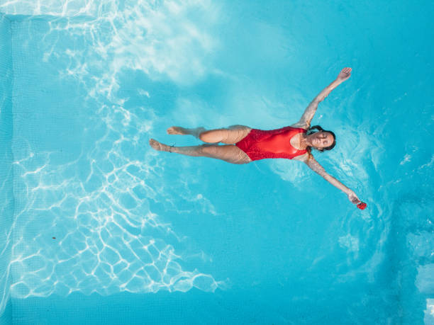 istock Woman Relaxing in a Modern Pool 2195560208