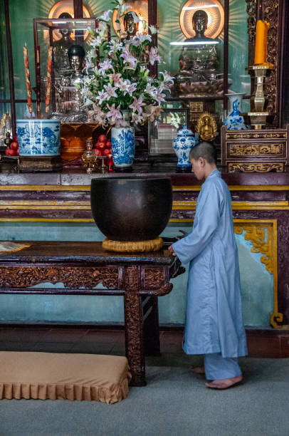 Hue, Vietnam - nov 24,  2013 : young Buddhist monk pray inside the Thien Mu pagoda, near Hue along the Perfume River
