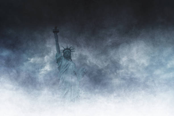 Statue of Liberty Partially Obscured by Thick Fog, Clouds and Smoke, Symbolizing Uncertainty and Mystery stock photo