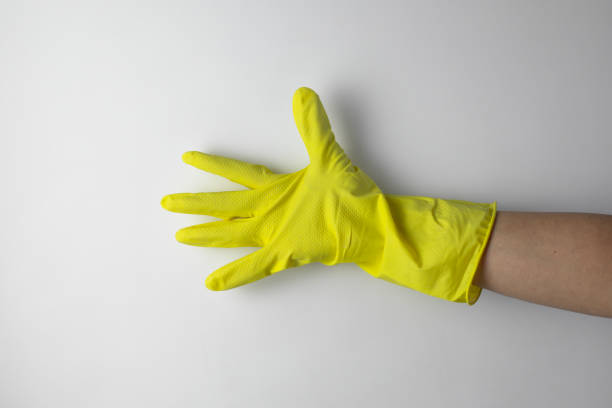istock Cleaning concept. A hand in a yellow glove for cleaning 2195565343