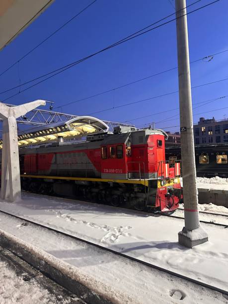 istock Red train is sitting on the tracks at night 2195567109