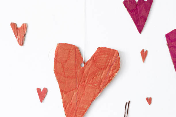 istock Red Paper Hearts on White Wall 2195568375
