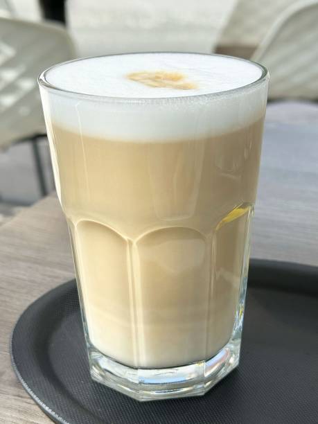 istock Iced latte with foam in a clear glass on a tray at cafe 2195568942