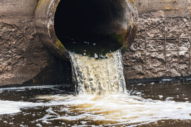 istock Dirty water flows from the pipe into the river, environmental pollution. Sewerage, treatment facilities 2195571066