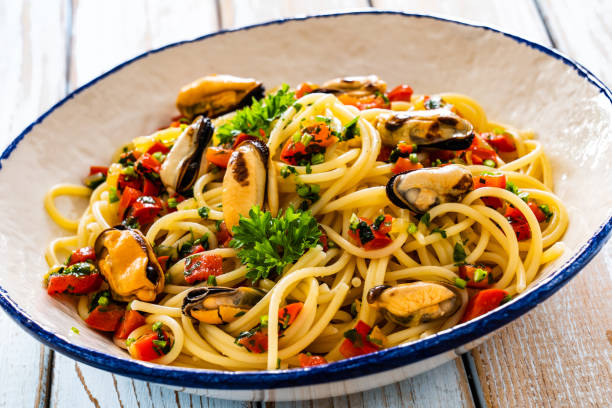 istock Noodles with mussels on wooden table 2195571279