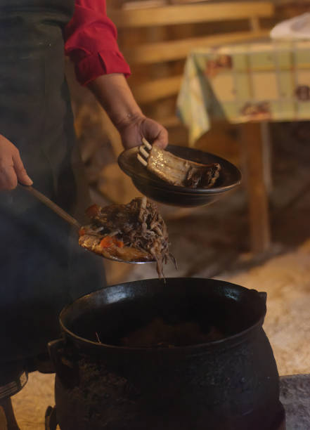 istock Mapuche woman serving food from an old pot on the fire 2195571923