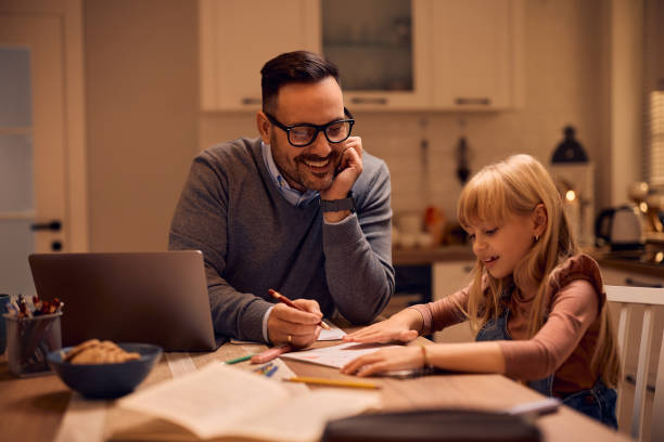 istock Happy man enjoying with his daughter while working at home. 2195573437