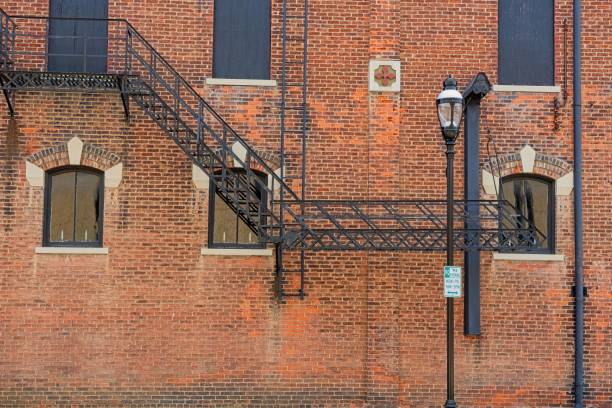 Exterior metal fire escape scales side of 19th century brick building