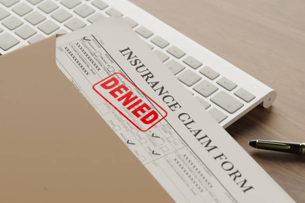 Denied health insurance application form on the table.