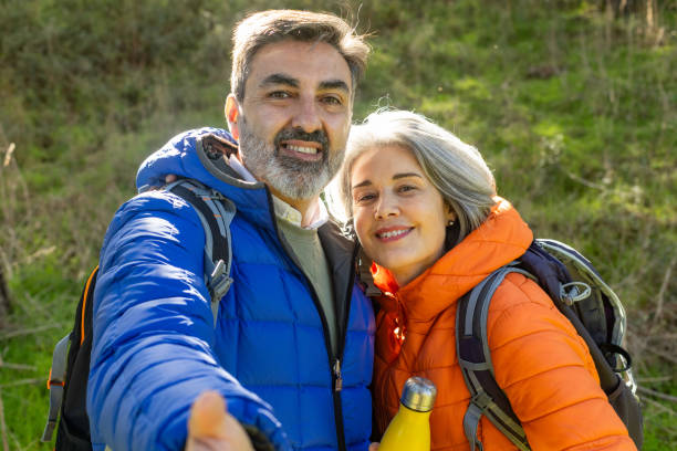 istock Happy senior couple taking a selfie while hiking in the woods 2195575209
