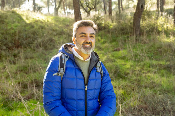 istock Smiling hiker enjoying nature in sunny forest during hiking trip 2195575213