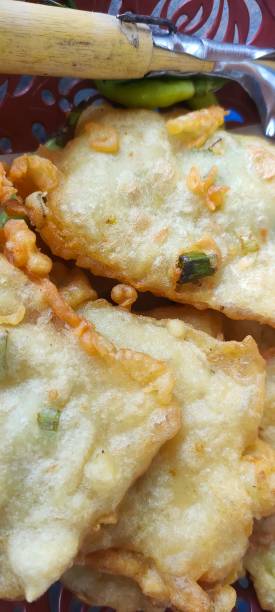 istock Close-up of crispy fried tempeh with green onions. 2195576930
