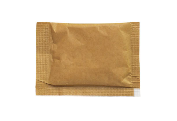 istock Blank brown paper sachet sugar bag isolated on white background 2195579893