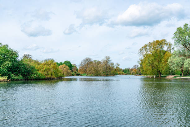 istock Verulamium park lake reflecting a cloudy sky in st albans, england 2195588043