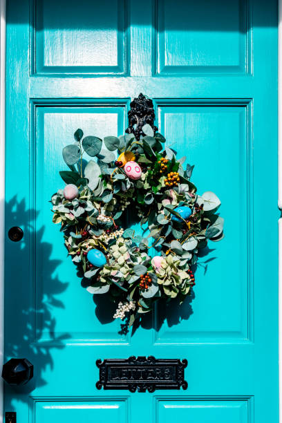 istock Easter wreath hanging on a turquoise front door in st. Albans, england 2195588282