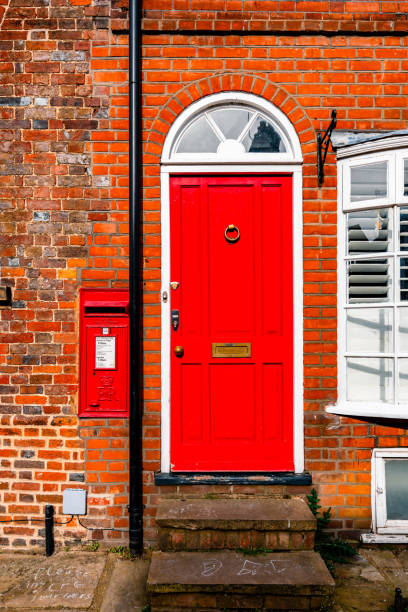 istock Red door and postbox on a brick wall in st. Albans, england 2195588288