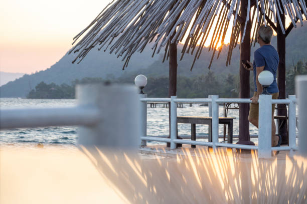 istock Mature man relaxes under palapa at sunrise 2195588848