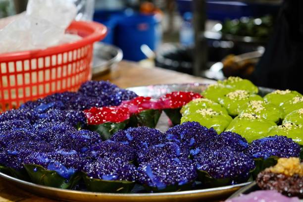 a tray of khanom tako (coconut cream and rice flour puddings) for sale at a floating market in bangkok - khlong toei stock-fotos und bilder