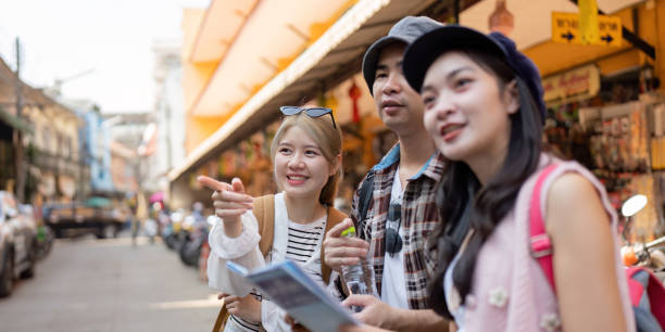 istock Friends exploring a vibrant market, studying a map while traveling and sharing moments of discovery 2195594841