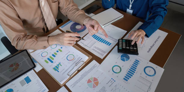 istock Accountants collaborating on financial analysis and performance metrics in a modern workspace 2195594921