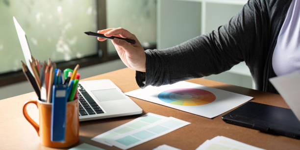 istock Graphic designer using a stylus at her desk while exploring color palettes and digital tools 2195595462