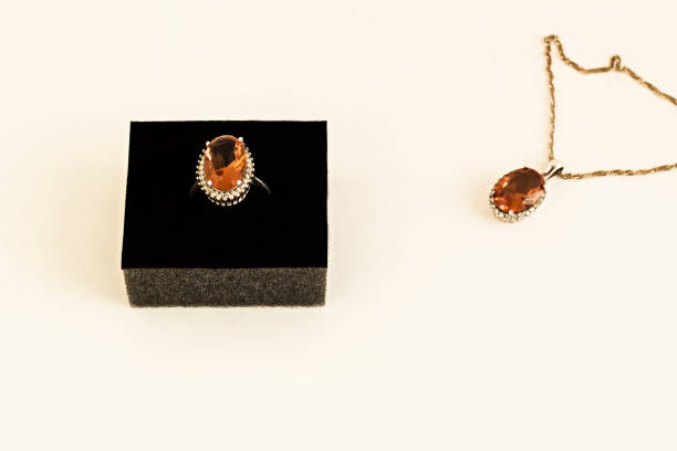 Close-up taken of Diaspore Stone Ring and Necklace on white surface.