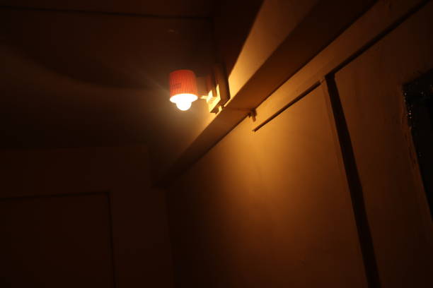 istock Close of a yellow light lamp in dark 2195600814
