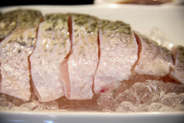 Fish sliced shabu arranged on ice in white plate table background