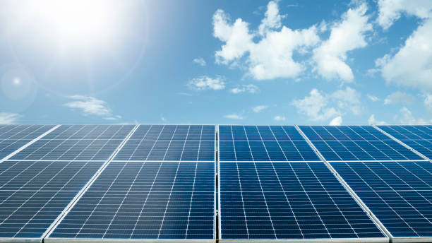 istock Photovoltaic solar power panel on blue sky and sunlight background. Green clean alternative and renewable energy concept. 2195607675