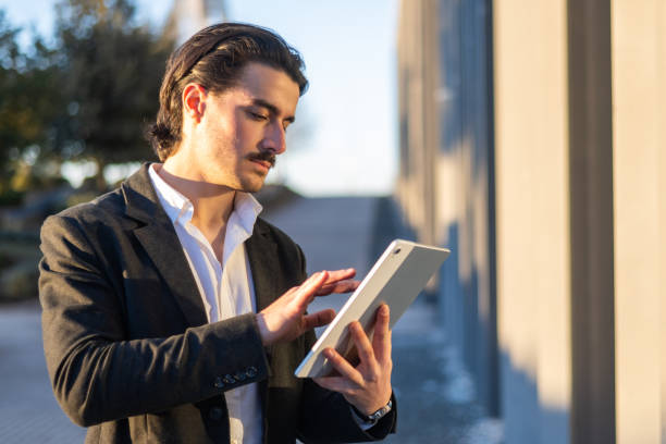 istock Confident Entrepreneur Holding Tablet Near Office Building, Authentic Success In Online Work And Business Communication. 2195611339