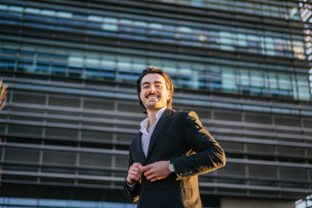 istock Confident Businessman Smiling Outdoors, Representing Professional Growth Solutions In Banking, Real Estate, Or Insurance Industries With A Positive And Trustworthy Presence. 2195611355